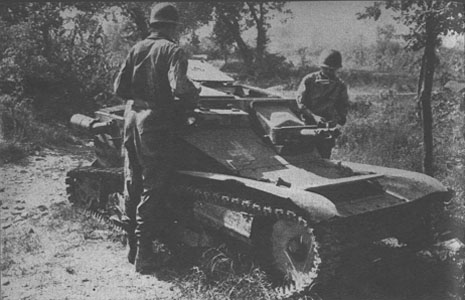[91st Men pause to inspect a captured German two man tankette]