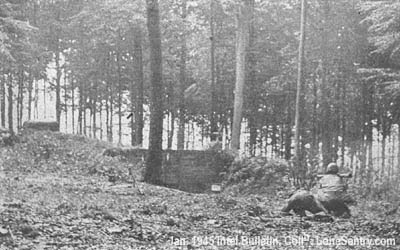 [U.S. soldiers fire a bazooka into a pillbox in the Siegfried Line.]