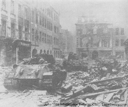 [Red Army T-34 tanks rendezvous in the rubble of a Berlin square.]