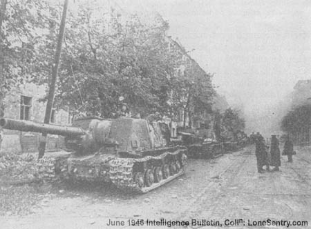 [A group of Soviet 152-mm self-propelled gun-howitzers halt on the side of an avenue during the fight for Berlin.]
