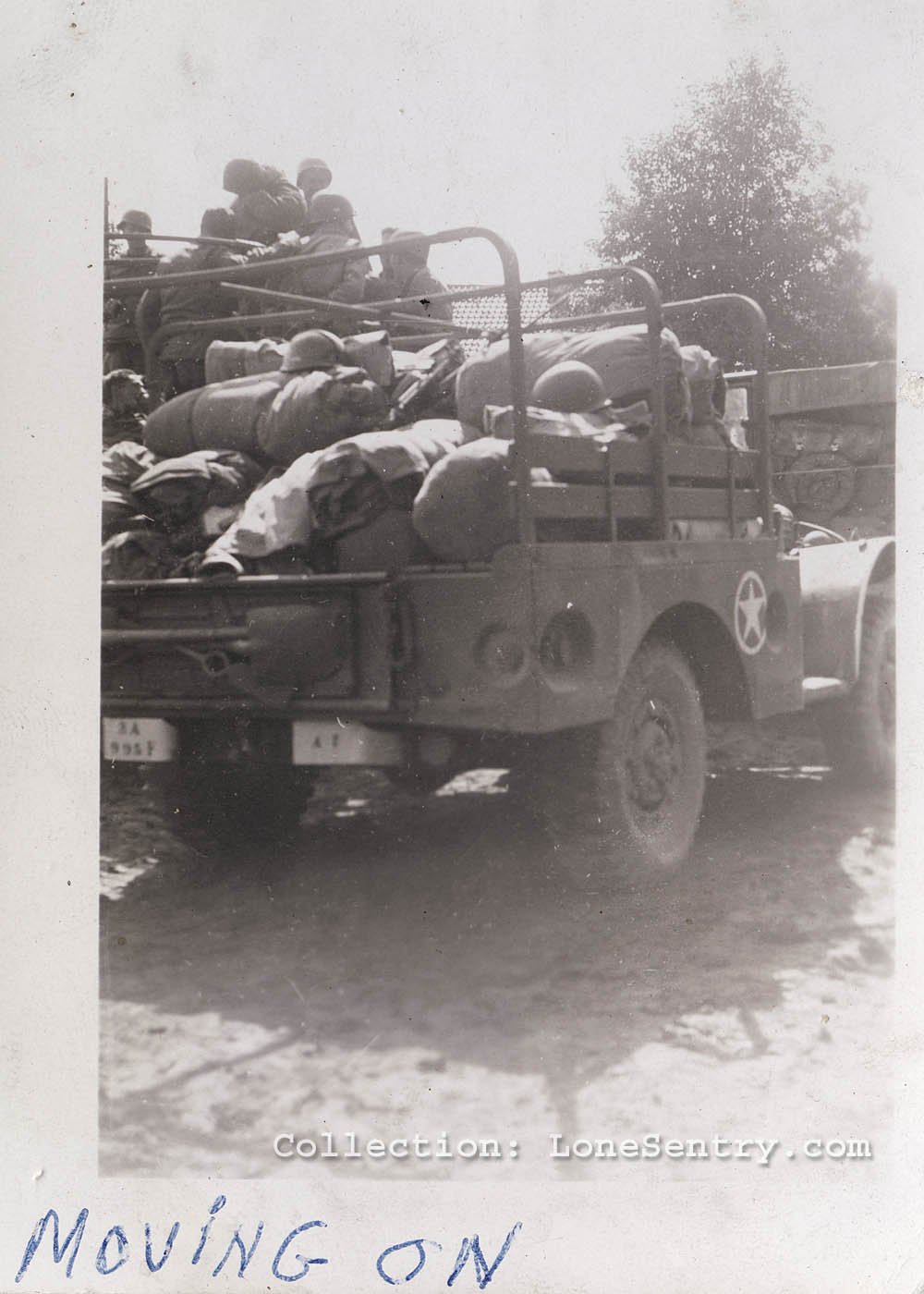 Vehicles of the 995th Field Artillery Battalion are loaded for a unit move somewhere in Europe. (Collection LoneSentry.com)