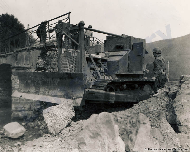 An armored bulldozer of 103rd Engineer Combat Battalion, 28th Infantry Division at work in Europe during WWII.