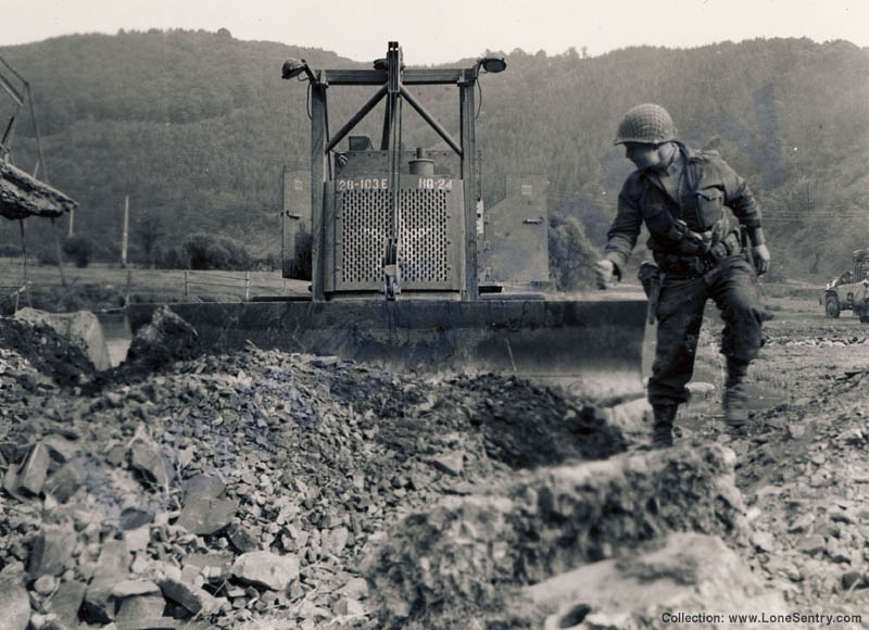 An armored bulldozer of 103rd Engineer Combat Battalion, 28th Infantry Division at work in Europe during WWII.