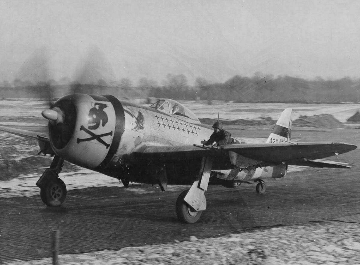 Ground Crewman Rides the Wing of a P-47 Thunderbolt