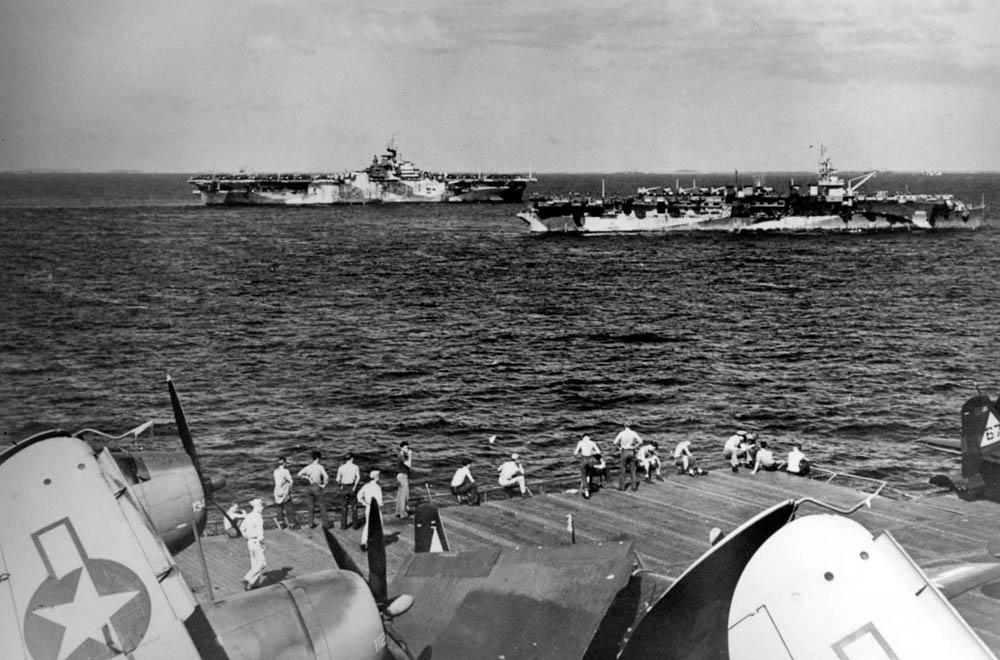 Two U.S. Navy aircraft carriers, USS Hornet (CV-12) and USS Independence (CVL-22), are photographed from the flight deck of the USS Wasp (CV-18) in January 1945.