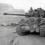 A British Sherman Firefly tank patrols in Namur, Belgium along the Meuse River during the Battle of the Bulge, December 1944. (U.S. Army Photograph.)