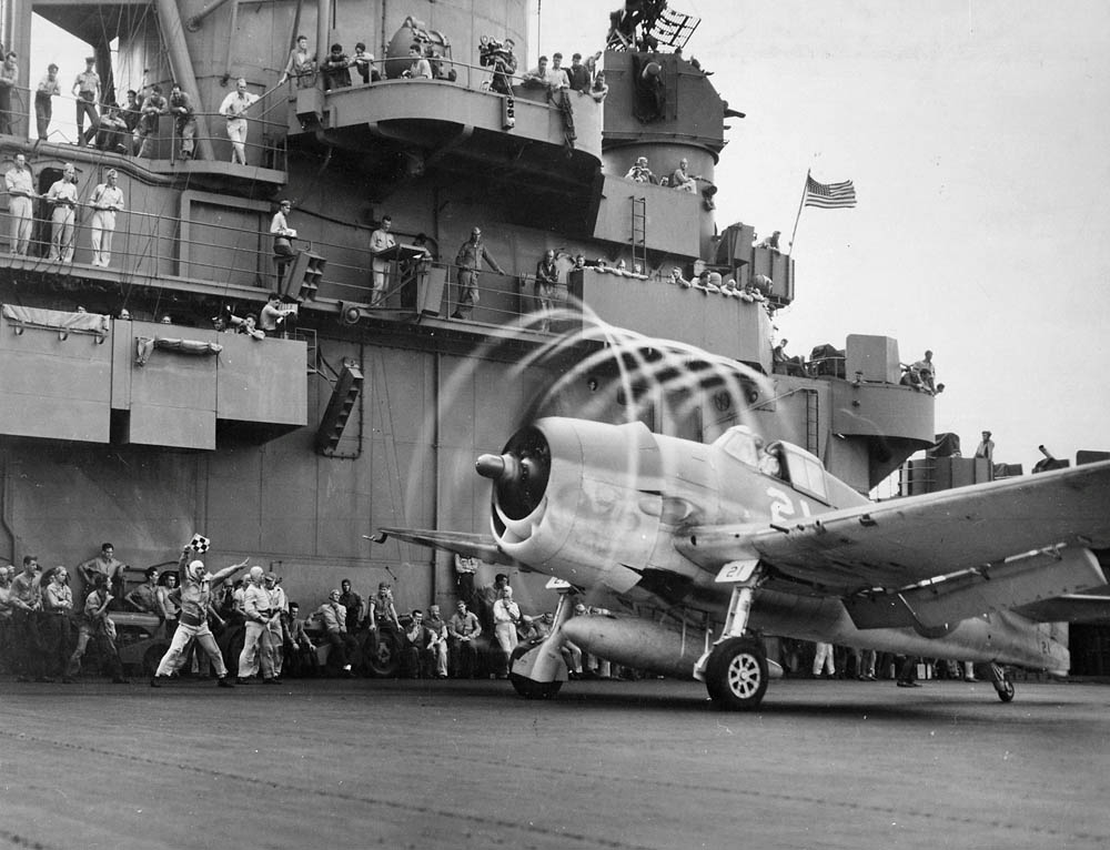 An F6F Hellcat's propeller blades leave a visible trail of condensation on the USS Yorktown. (U.S. Navy Photograph / NARA.)