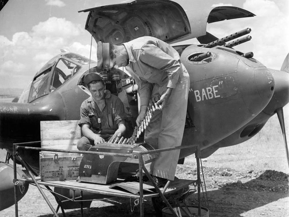 Ammunition for the 20mm nose gun in the Lockheed P-38 Lightning Babe is inspected. (U.S. Air Force Photograph)