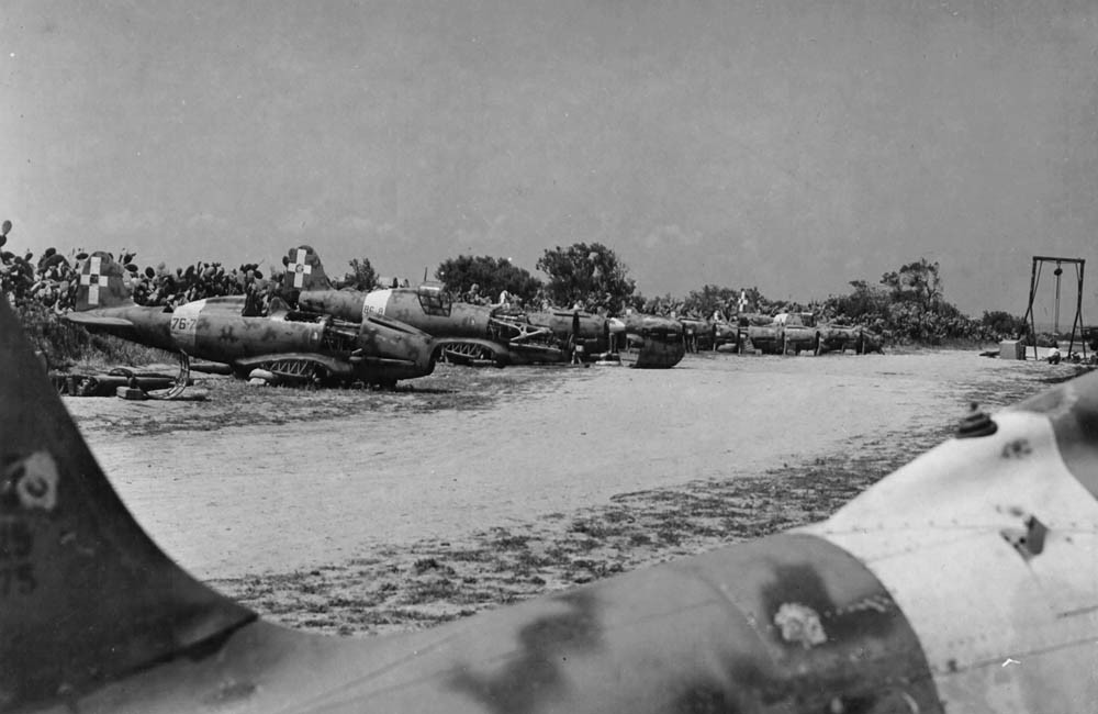 Destroyed Italian aircraft, including several Macchi C.202 Folgore fighters, at the edge of an airfield in Tunisia. (U.S. Air Force Photograph.)