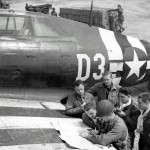 Pilots of U.S. 9th Air Force consult maps on the wing of a P-47 Thunderbolt fighter-bomber near St. Mere Eglise, France in June 1944. (U.S. Air Force Photograph.)