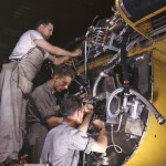 Factory workers wire the right engine of a B-25 bomber under assembly at North American Aviation in Inglewood, California, June 1942. (Alfred T. Palmer / U.S. Library of Congress.)