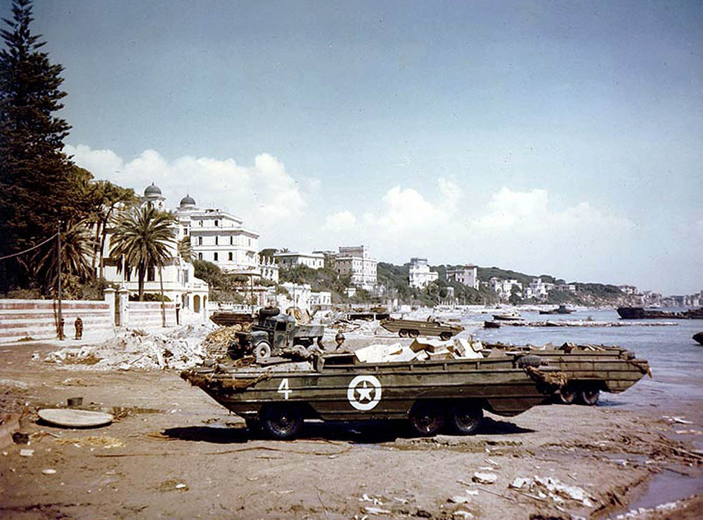 Color photograph of U.S. Army DUKW amphibious trucks on the beach at Anzio, Italy during Operation Shingle, April 1944. (Official U.S. Navy Photograph.)