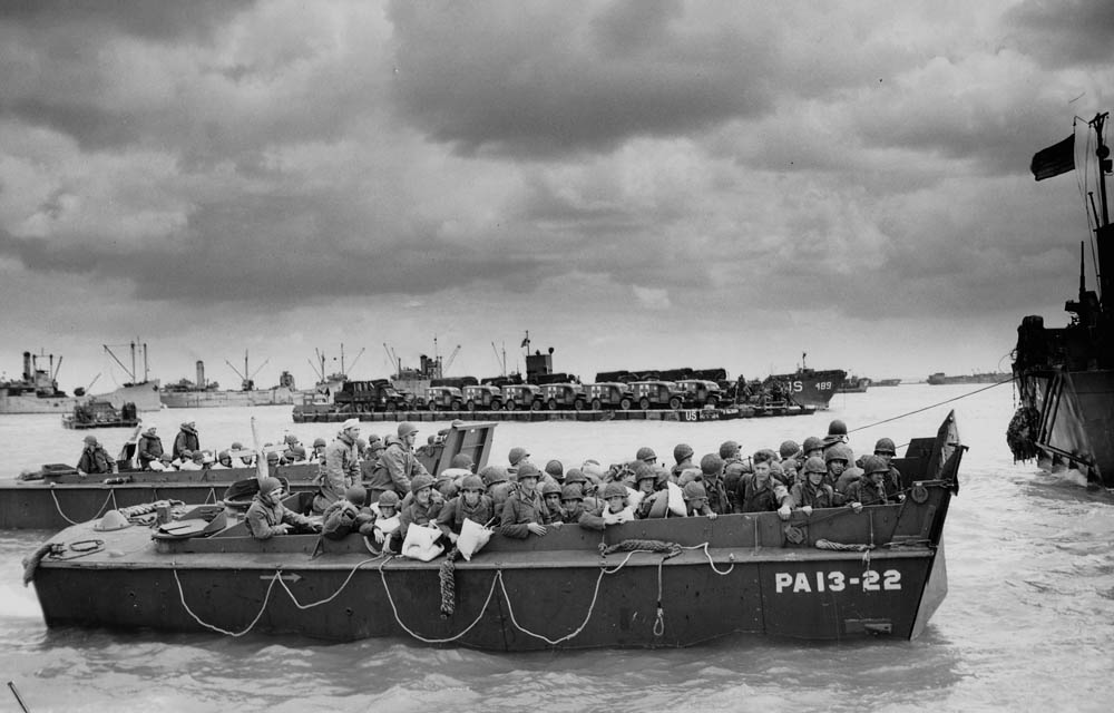 U.S. troops in an LCVP (Landing Craft, Vehicle, Personnel) prepare to land on Utah Beach on D-Day, June 6, 1944. The foreground LCVP was assigned to the U.S. Navy attack transport USS Joseph T. Dickman (APA-13). U.S. Army Photograph.