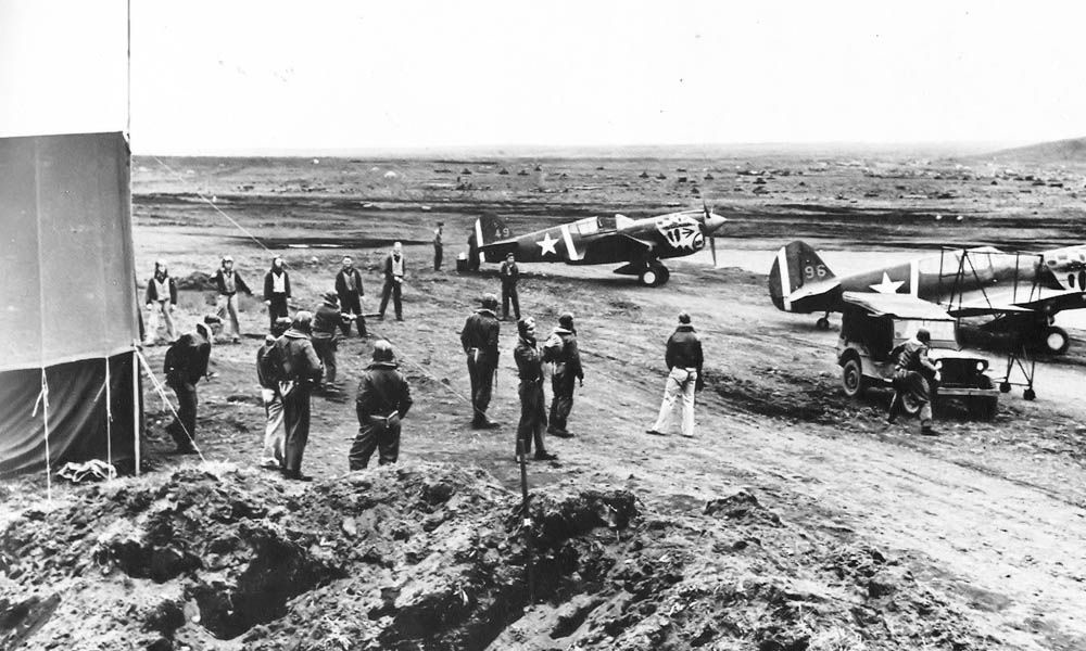 Pilots and P-40 Warhawk aircraft of the 11th Fighter Squadron at Fort Glenn Army Air Base, Alaska, June 1942. (U.S. Air Force Photograph.)