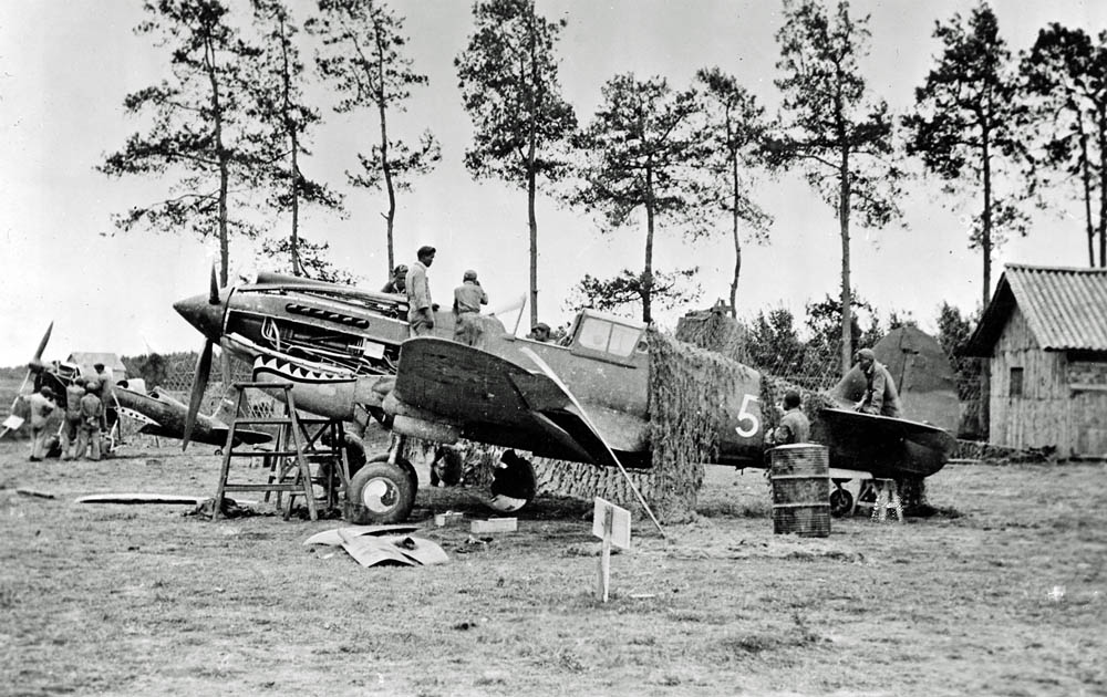 A P-40 Warhawk of the Flying Tigers undergoes maintenance at Kunming, China during World War II. (U.S. Air Force Photograph.)