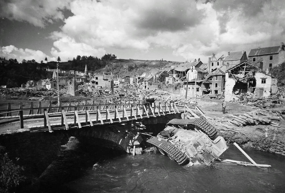 Destroyed town of Houffalize, Belgium including an overturned German Panther tank in the river after the Battle of the Bulge.
