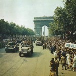 Allied tanks and halftracks pass through the Arc de Triomphe and parade down the Champs-Élysées after the liberation of Paris.
