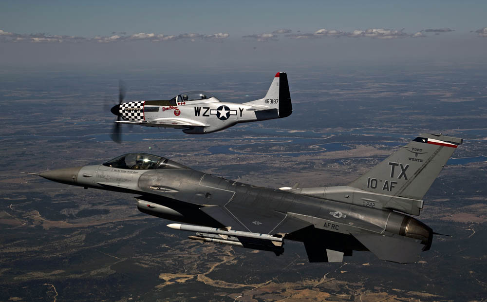 An F-16C Fighting Falcon, 457th Fighter Squadron, flies in formation with a P-51 Mustang over Naval Air Station Fort Worth Joint Reserve Base, Texas, Oct. 3, 2014.