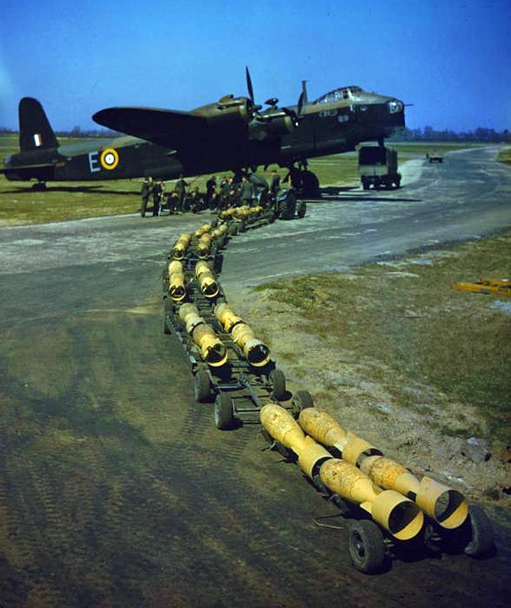 Sixteen 250 lb. bombs wait to be loaded on a Short Stirling bomber of No. 1651 Heavy Conversion Unit at Waterbeach, Cambridgeshire. (Imperial War Museum Photograph.)