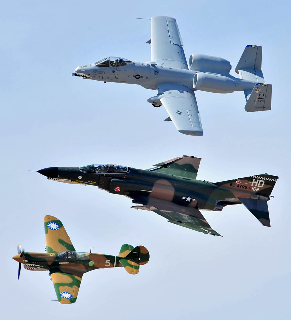 A-10 Thunderbolt II (top), F-4 Phantom (middle), and P-40 Warhawk fly in formation during the Heritage Flight Conference.