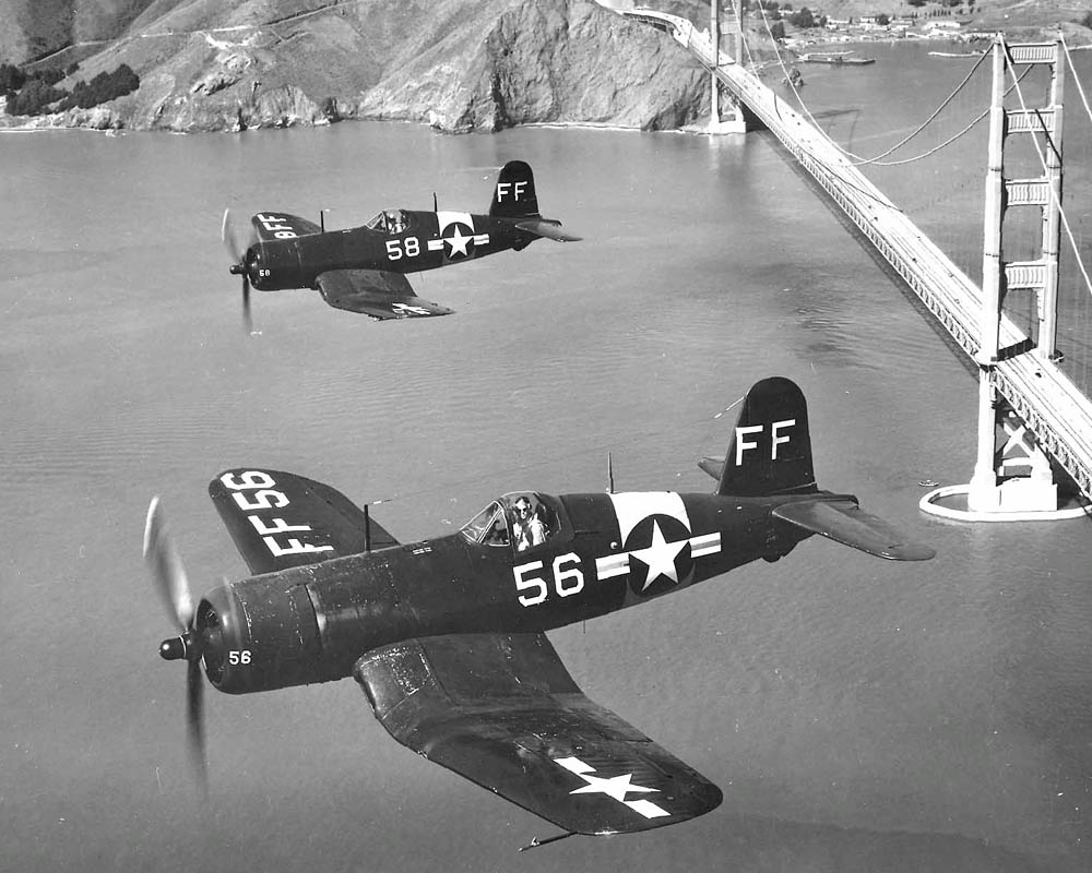 A pair of Goodyear FG-1D Corsairs flying over the Golden Gate Bridge in San Francisco.