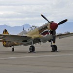 A P-40N Warhawk Air Force Heritage aircraft on the flight line at Davis-Monthan Air Force Base, Ariz., during the Heritage Flight Training Course (HFTC) March 1, 2014. Additional aircraft participating in the HFTC were the P-51 Mustang, the P-38 Lightning, the P-47 Thunderbolt and the F-86 Sabre. Air Combat Command aircraft include the F-22 Raptor, A-10 Thunderbolt II and the F-16C Fighting Falcon.
