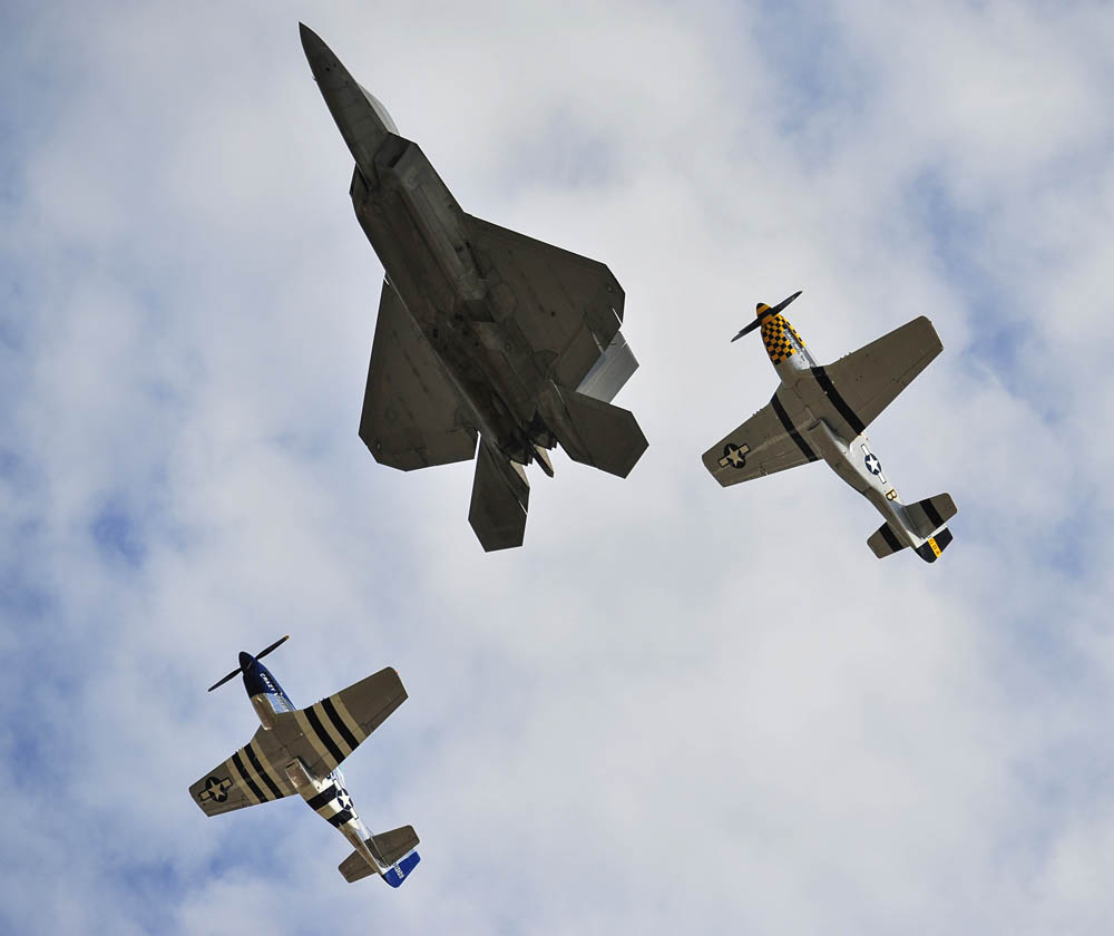 A F-22 Raptor leads a heritage flight at the Gulf Coast Salute open house and air show April 11, over Tyndall Air Force Base. The air show and open house featured the Air Force Thunderbirds, the F-22 Raptor demo team, and the Army Golden Knights.