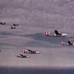 P-51 Mustangs provide cover to a formation of Consolidated B-24 Liberators of the 8th Air Force over England. (U.S. Air Force Photograph.)