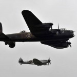 A British Avro Lancaster and Supermarine Spitfire perform The Battle of Britain Memorial Flight for thousands of spectators July 14, 2012, during the Farnborough International Air Show in Farnborough, England. (U.S. Dept. of Defense Photo by Tech. Sgt. Lee Osberry.)
