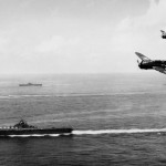 Curtiss SB2C-4 Helldiver dive bombers of Bombing Squadron 83 (VB-83) fly over the USS Essex (CV-9) off the coast of Okinawa, May 1945. (U.S. Navy Photograph.)