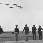 Soldiers from the 379th BG watch a formation of Boeing B-17 Flying Fortresses return to base after a mission in June 1944. (U.S. Air Force Photograph.)