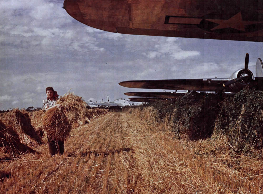 Farmers gather crops in England in the midst of dispersed B-17 Flying Fortresses of Eighth Air Force. (U.S. Air Force Photograph.)