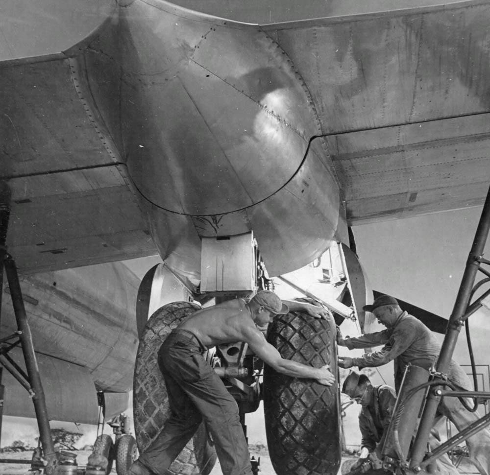 A Boeing B-29 Superfortress has a wheel changed by ground crew at North Field on Guam, May 1945. (U.S. Air Force Photograph.)