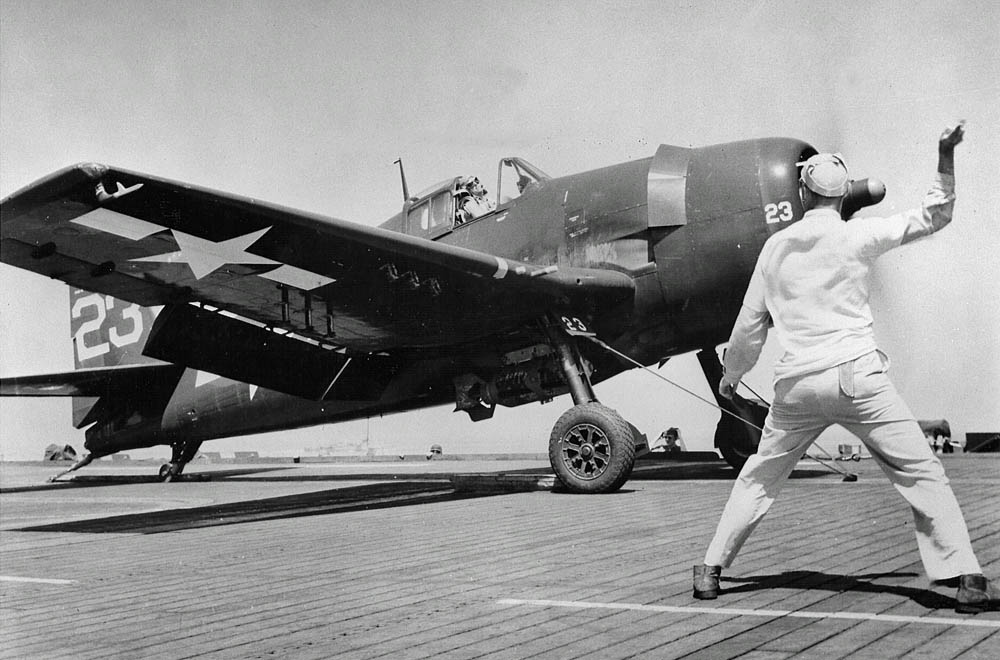 U.S. Navy sailors on the escort carrier USS Kasaan Bay launch a Grumman F6F-5 Hellcat of Fighting Squadron 74 (VF-74) during the invasion of Southern France. (U.S. Navy Photograph.)