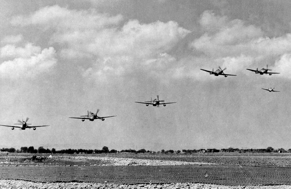 A group of North American P-51 Mustang fighters from the 332nd Fighter Group take off from an airfield in Italy to escort heavy bombers. (U.S. Air Force Photograph.)