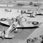 Supermarine Spitfire Mark Vs of No. 322 Wing RAF parked on pierced steel planking in Algeria. (Imperial War Museum Photograph.)