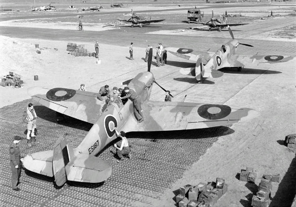 Supermarine Spitfire Mark Vs of No. 322 Wing RAF parked on pierced steel planking in Algeria. (Imperial War Museum Photograph.)