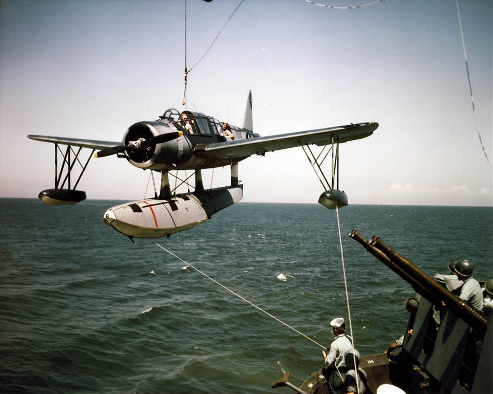 A Vought OS2U Kingfisher is hoisted aboard the USS Missouri (BB-63) in the summer of 1944. (U.S. Navy Photograph.)