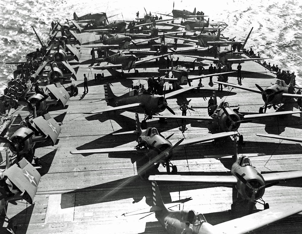 Grumman F4F-4 Wildcats and Royal Air Force Supermarine Spitfires on the deck of the aircraft carrier USS Wasp (CV-7), April 1942. (U.S. Navy Photograph.)