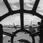 Dispersed aircraft on Saipan are seen through the plexiglas nose of a Boeing B-29 Superfortress. (U.S. Air Force Photograph.)
