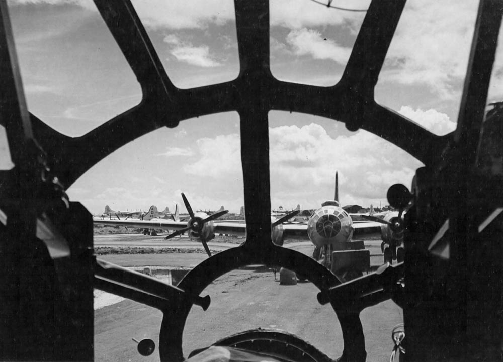 Dispersed aircraft on Saipan are seen through the plexiglas nose of a Boeing B-29 Superfortress. (U.S. Air Force Photograph.)