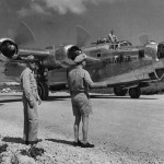 Two officers watch the B-24 Liberator "Bolivar Jr." of 431st BS, 11th BG taxi to a hardstand, May 1945. (U.S. Air Force Photograph.)