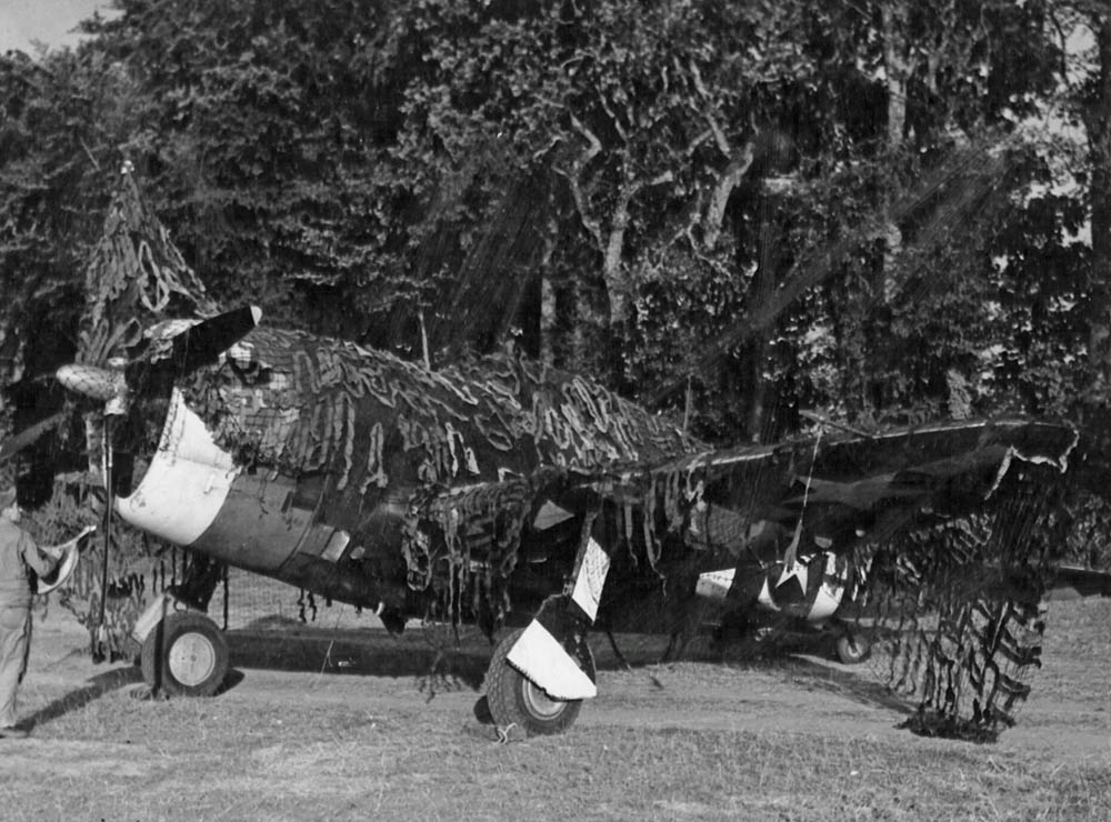 A camouflage Republic P-47 Thunderbolt fighter parked on an airfield near St. Lo, France during the summer of 1944. (U.S. Air Force Photograph.)