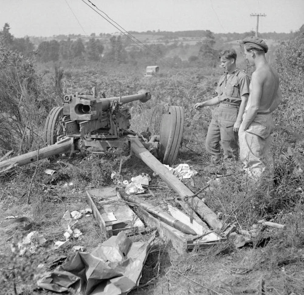 British troops inspect a destroyed German 75mm antitank gun captured near Mont Pincon, France in August 1944. (Imperial War Museum Photograph.)