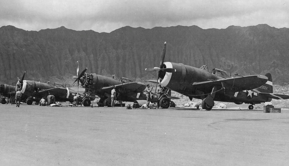 Republic P-47 Thunderbolt fighters of the 318th Fighter Group are serviced by mechanics at Bellows Field, Oahu, Hawaii, May 1944. (U.S. Air Force Photograph.)