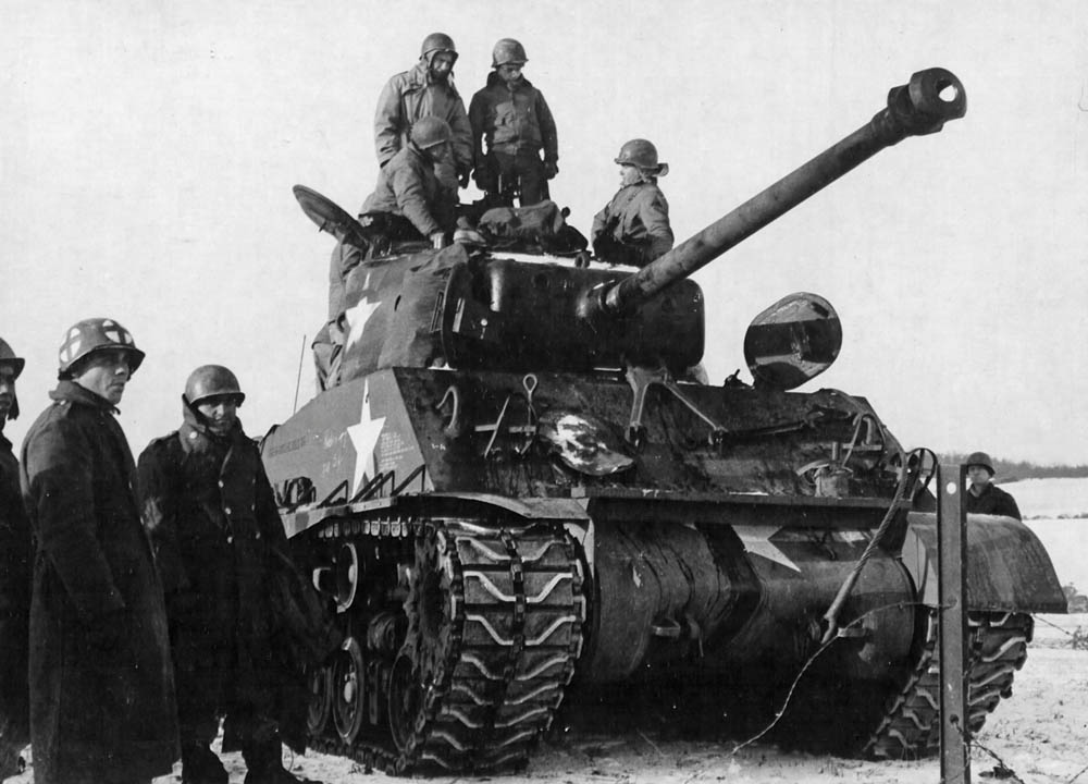 Pilots from the 354th Fighter Group inspect an M4 Sherman tank of the 4th Armored Division during a tour of the front. (U.S. Air Force Photograph.)