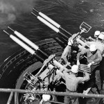 A gun crew fires 40mm Bofors guns aboard the escort carrier USS Badoeng Strait, circa 1948. (U.S. Navy Photograph.)