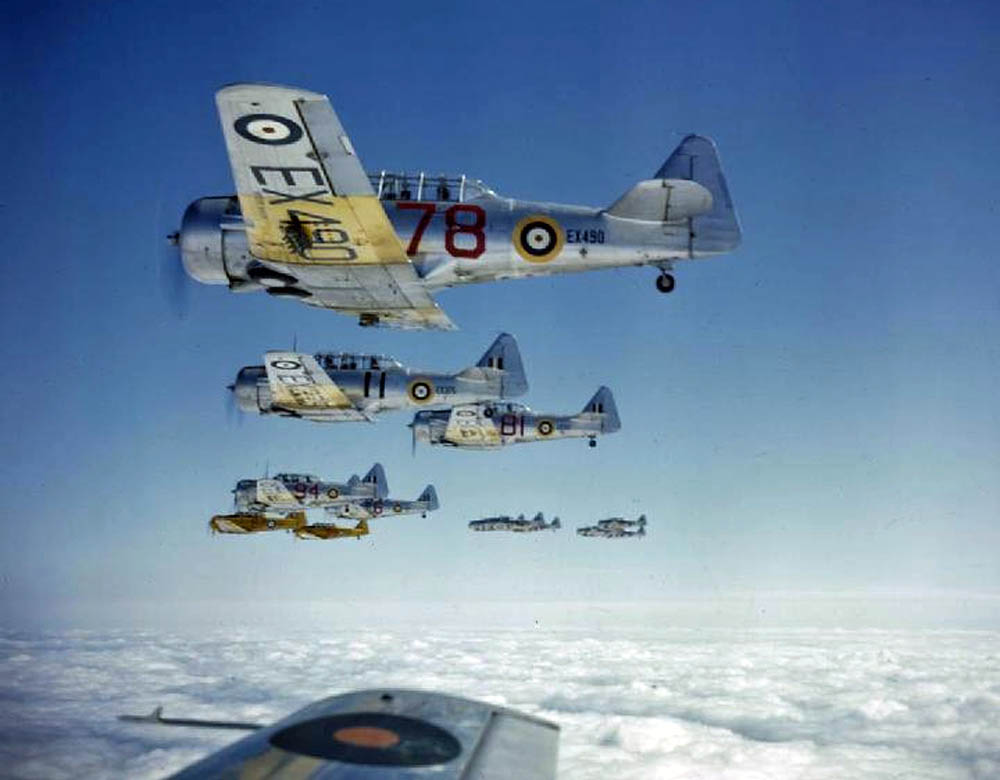 Color photograph of a formation of Royal Air Force North American Harvard IIAs flown by RAF trainee pilots over Rhodesia, January 1943. (Imperial War Museum Photograph.)