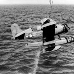 A Curtiss SOC-1 Seagull seaplane is recovered from the water by a U.S. Navy ship in July 1943. (Official U.S. Navy Photograph.)