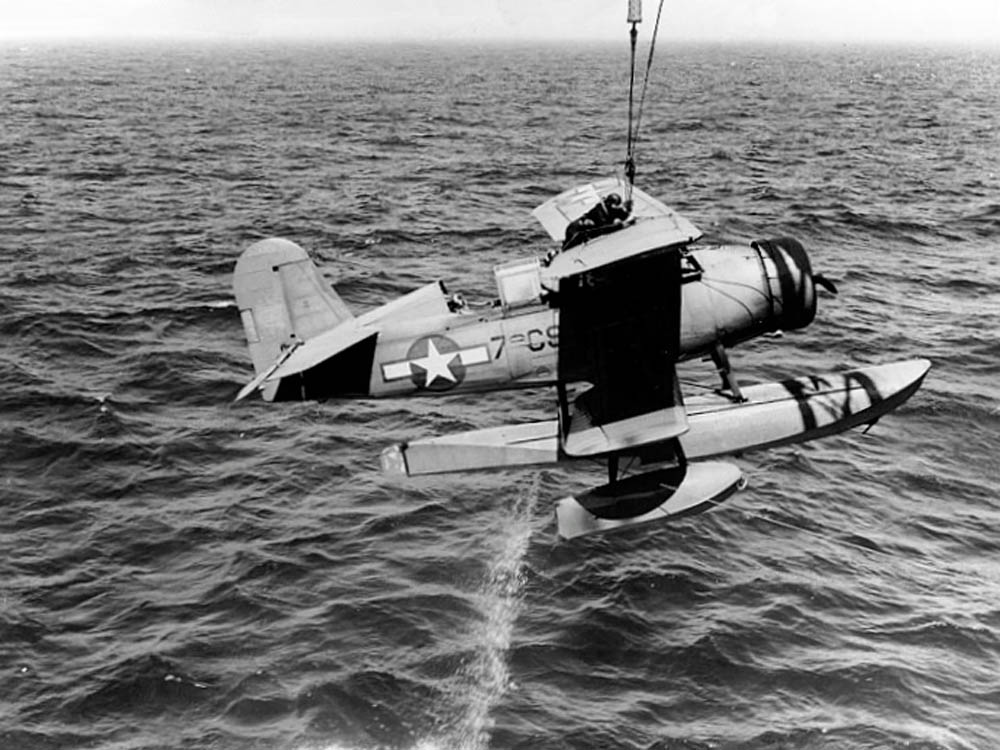 A Curtiss SOC-1 Seagull seaplane is recovered from the water by a U.S. Navy ship in July 1943. (Official U.S. Navy Photograph.)